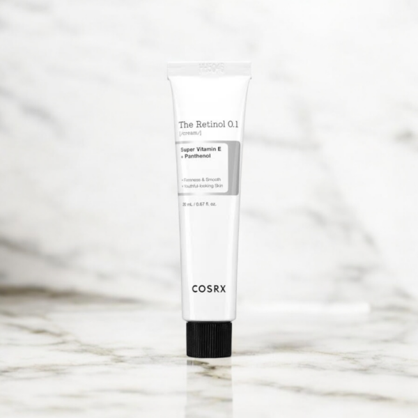 Vue en flat lay du tube de COSRX The Retinol 0.1 Cream, mettant en valeur son design épuré et ses bienfaits anti-âge.
